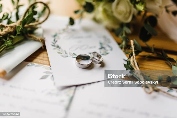 Stylish Rings Flowers On Wooden Table Background Letters From The Bride And Groom Vows Engagement Luxury Marriage And Wedding Accessory Concept Stock Photo - Download Image Now