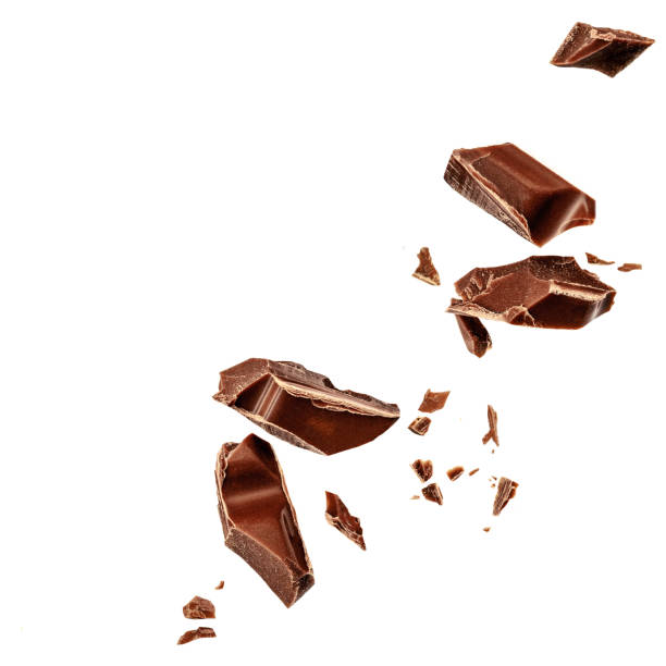 白い背景に浮揚するミルクチョコレートの塊。フライングチョコレートのかけら、削りくず、ココアのパン粉の上面図。フラットレイ - air flow ストックフォトと画像