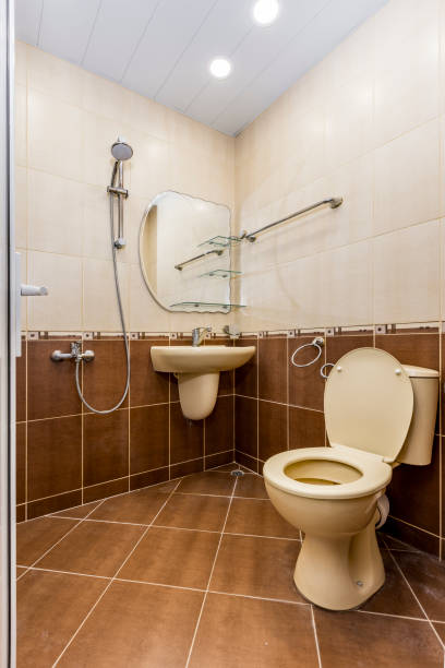 istock Old shower bathroom with brown tiles 1455770650