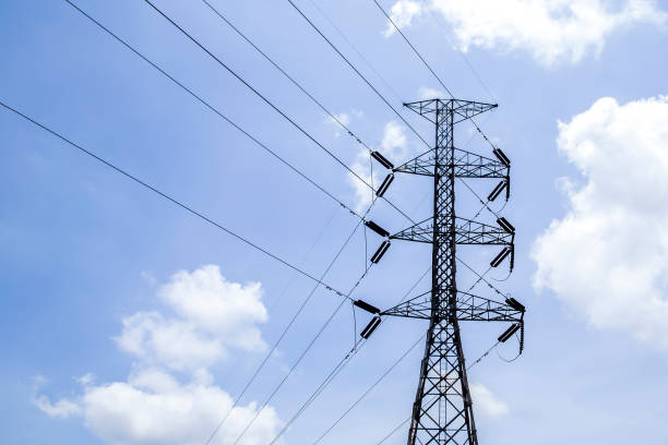 istock High voltage poles with sky and clouds in the background. 1455770656