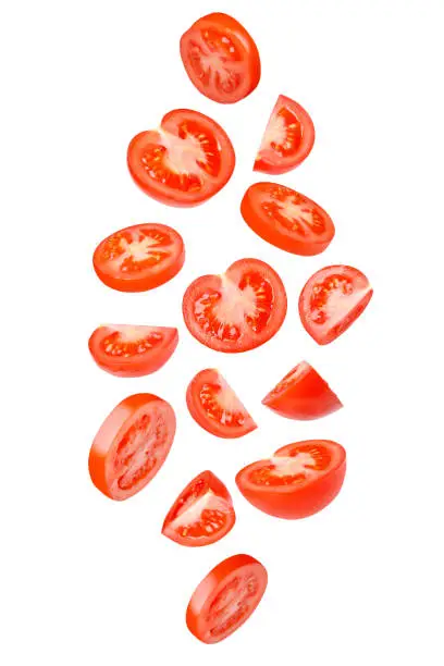 Photo of Flying tomatoes cut into different shapes. Tomatoes, tomatoes, cut, fresh tomatoes. Isolated.