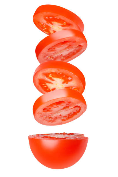 istock Flying tomatoes cut into circles. Tomatoes, tomatoes, cut, fresh tomatoes. Isolated. vertically. Part of the tomato from below. 1455772862