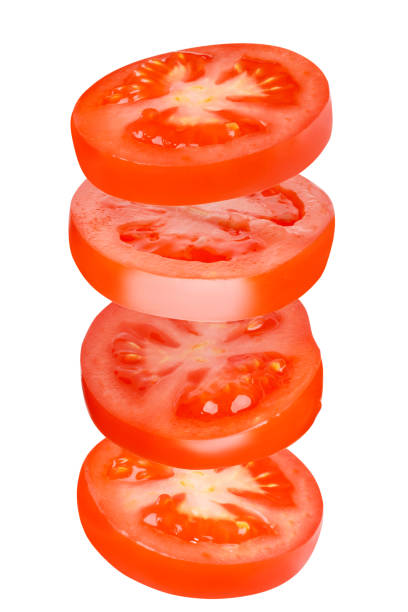 istock Flying tomatoes cut into circles. Tomatoes, tomatoes, cut, fresh tomatoes. Isolated. Vertical 1455773046