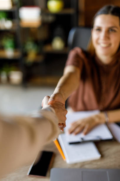 istock Two businesswomen shaking hands when meeting to collaborate on a project 1455773117
