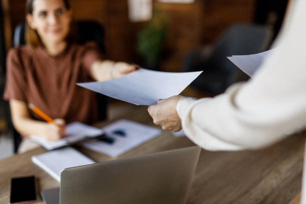 istock Businesswoman handing her colleague a document 1455773127