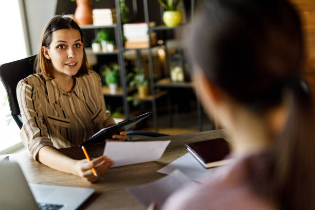 istock Manager asking young woman questions during a job interview 1455773859
