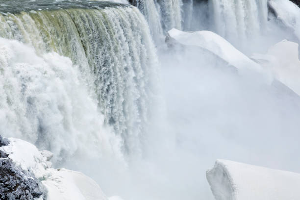 Niagara Falls during winter, mist rising, USA.