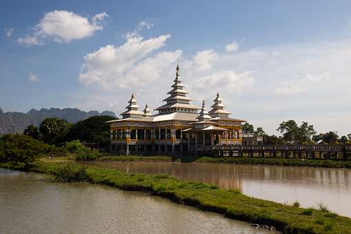 Kyaut Ka Latt Pagoda in Hpa-An . A beautiful pagoda sits atop a rock amongst stunning scenery