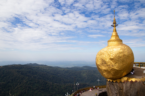 The golden rock with gold flakes placed by local visitors, The Kyaik Htee Yoe Pagoda, also known as the Kyaiktiyo Pagoda is a very special place that draws in many visitors in Southern Myanmar