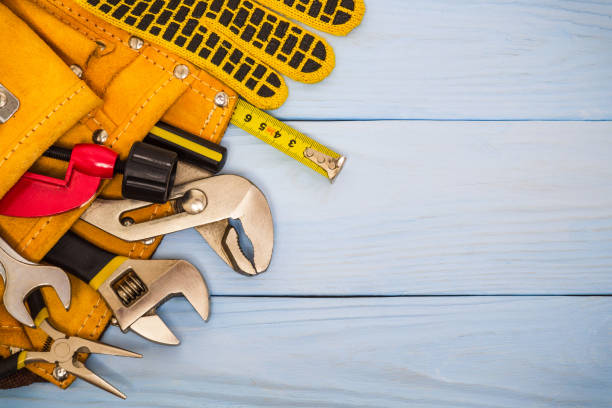istock Professional plumber craftsman tool folded in a suede bag on blue boards 1455785260