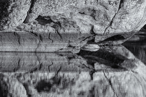 Landscape with granitic rock reflected in a lagoon. Natural Area of Barruecos. Extremadura. Spain.