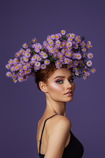 Young beautiful girl with wreath of flowers on her head