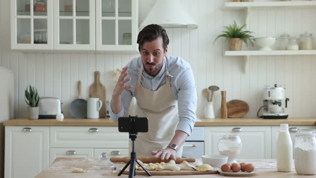 Guy blogger record video, share pastry recipe on smartphone camera