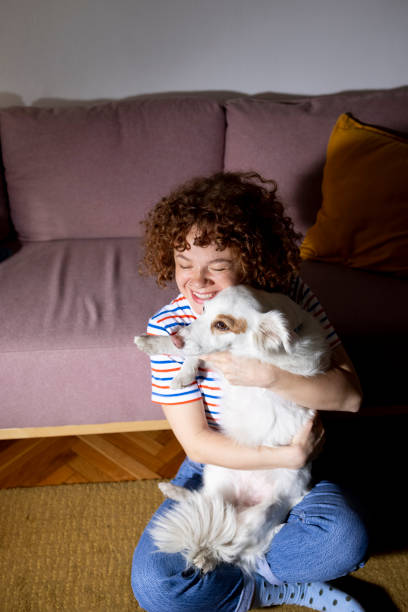 istock Woman hugging her dog 1455791497