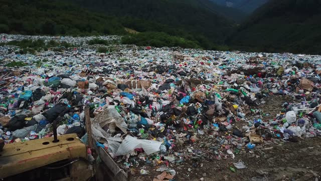 Garbage pollution of the Carpathian mountain massifs. Workers at the dump. Garbage is sorted for recycling.