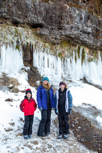 istock Three Kids Exploring Riverbank in Winter 1455792610