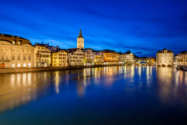 Limmat River waterfront in downtown Zurich Switzerland at twilight blue hour.
