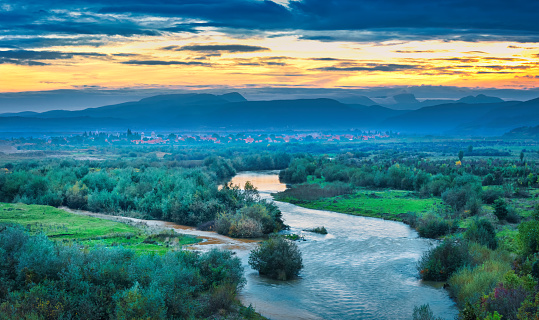 Aries River and the Western Carpathians in Cluj County, Transylvania, Romania at sunset.