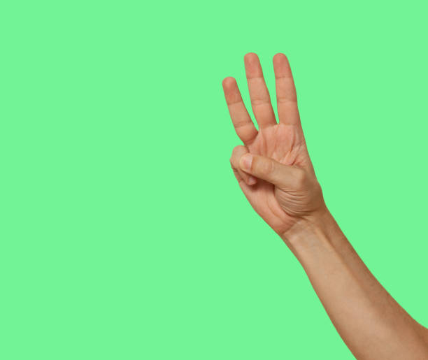istock Three fingers raised up isolated on green screen background 1455796165