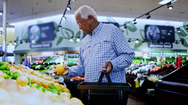 Senior Black man browsing produce in grocery store