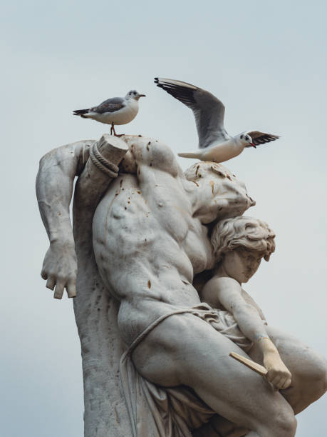 istock Low angle shot of two seagulls standing on a statue 1455804688