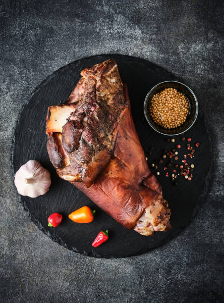 istock Smoked pork knuckle with stewed cabbage and spices. Baked Eisbein. Smoked ham hock. 1455806902