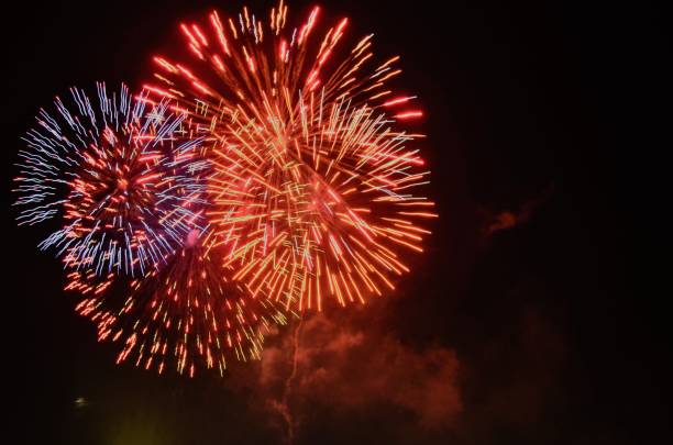 istock Fireworks lit up in the night sky 1455808489