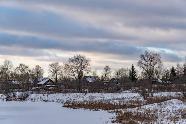 istock Rural landscape with village huts covered with white snow in winter. 1455810632