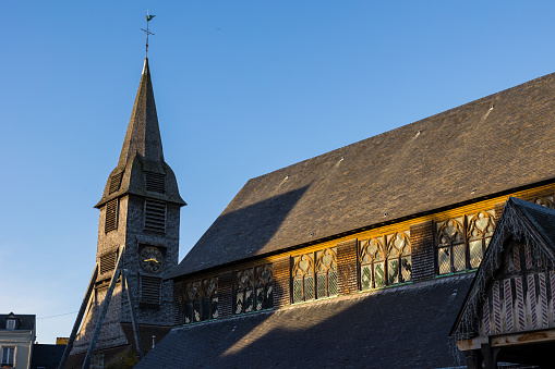 Wooden bell tower of the Sainte-Catherine de Honfleur church at sunset