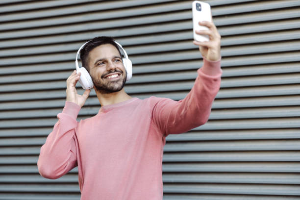 istock Young man filming a social media content 1455811040