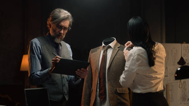 istock Tailors work on suit in designer atelier 1455812124