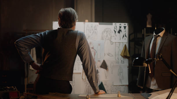 istock Tailor works with sketches of future clothes 1455812133