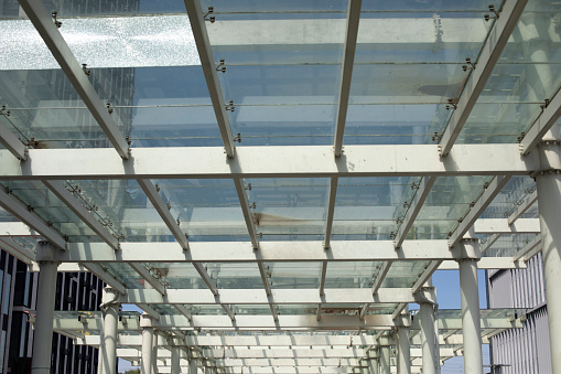 Glass ceiling. Transparent roof. Details of modern station. Steelwork. Glass architecture.