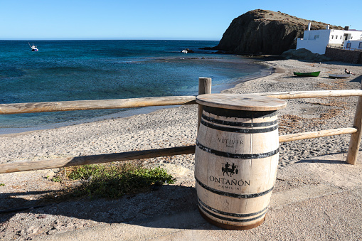 Isleta del Moro, Almeria, Spain- November 17, 2022: Bar with barrel table on Isleta del Moro beach on a sunny day
