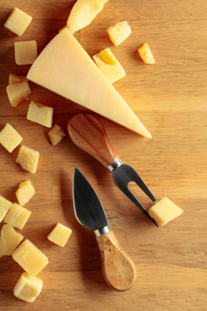 istock Parmesan cheese with fork and knife on a wooden background. 1455822266