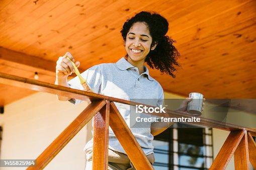 istock Woman painting deck 1455825964