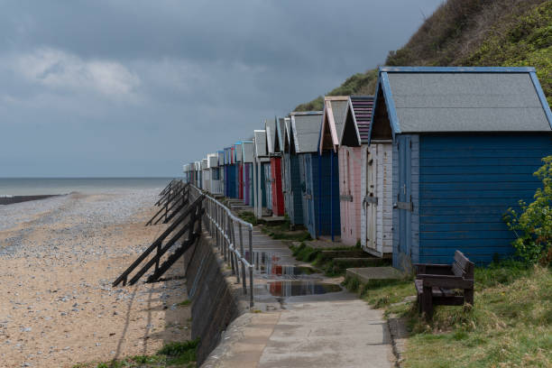 istock A row of beach huts on a pebbled beach 1455827269