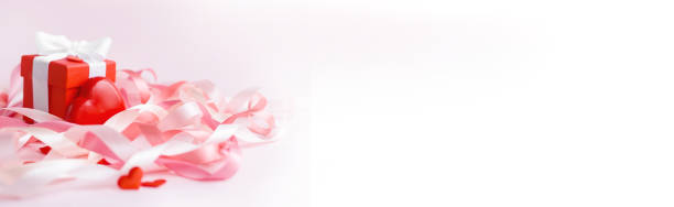 Happy Mother's Day or Valentine's day. Red heart on the background of blurred holiday ribbons. Banner Happy Mother's Day Valentine's day. Red heart on the background of blurred holiday ribbons. Greeting card. Banner with copyspace. Mock up valentine s day holiday stock pictures, royalty-free photos & images