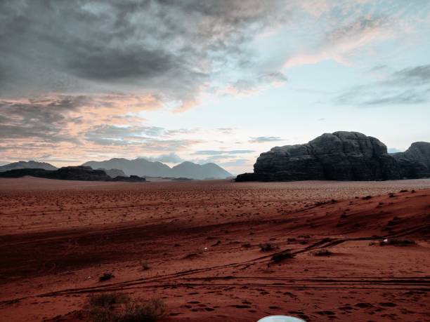 istock Aerial scenic view of Wadi Rum under cloudy sunset sky 1455828841