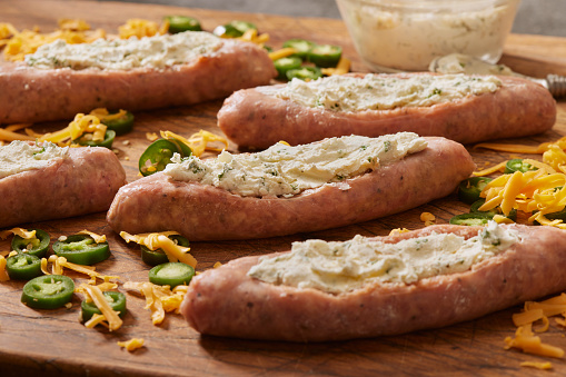 Preparing Stuffed Jalapeno Sausage Boats with Herb Cream Cheese and Cheddar