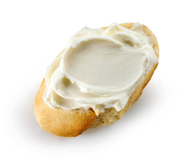 slice of baguette with cream cheese stock photo