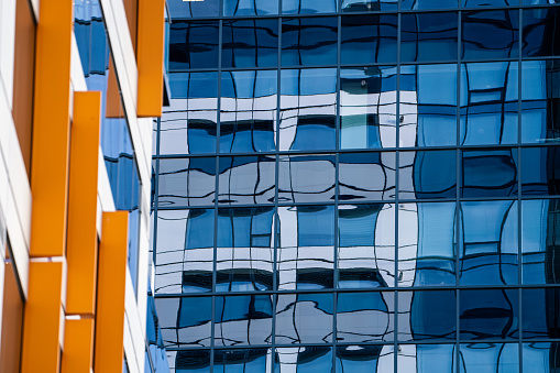 Reflection of a building in the side of a modern glass building in Bellevue Washington USA.