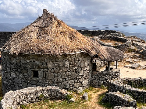 thatched roof house, archaeological remains, castros, in the town of A Guarda, Spain.