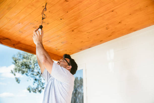 istock Man installing light bulbs on recently finished wooden porch 1455837804