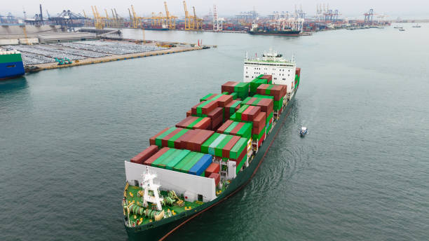 istock container ship transporting cargo logistics import export goods international around the world including Asia Pacific and Europe, global business and industry delivery services transportation ship box-container by sea, aerial view, 1455839899