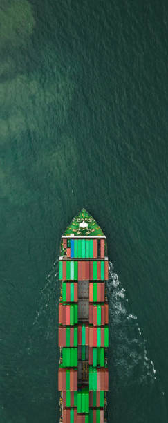 container ship transporting cargo logistics import export goods international around the world including Asia Pacific and Europe, global business and industry delivery services transportation ship box-container by sea, aerial drone point of view, copy space for web banners. buque portacontenedores transporte logística de carga importación exportación bienes internacionales en todo el mundo, incluidos asia pacífico y europa, servicios de entrega de negocios e industria globales transporte buque caja-contenedor por mar, pun