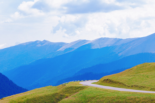 Transfagarasan road in Carpathian mountains in Romania . Blue mountains range