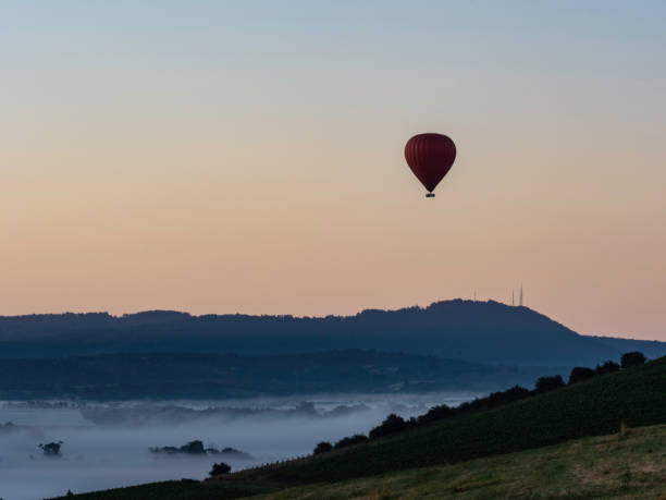 istock Hot air balloon over valley 1455840916