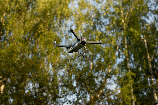 Drone in flight. Quadro copter in sky. Take-off of electric transport. Drone with camera for shooting.