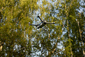 Drone in flight. Quadro copter in sky. Take-off of electric transport.